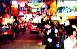 Jonny crosses street in Hong Kong.